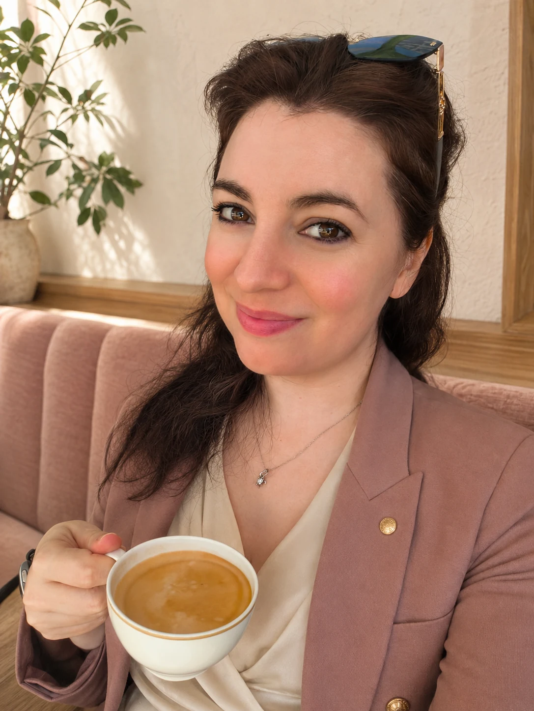 Stella Norsen holding a cup of coffee, ready to talk